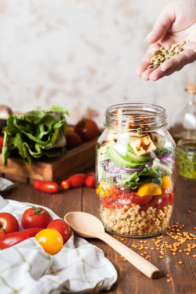 Jar of healthy foods including nuts, seeds and vegetables